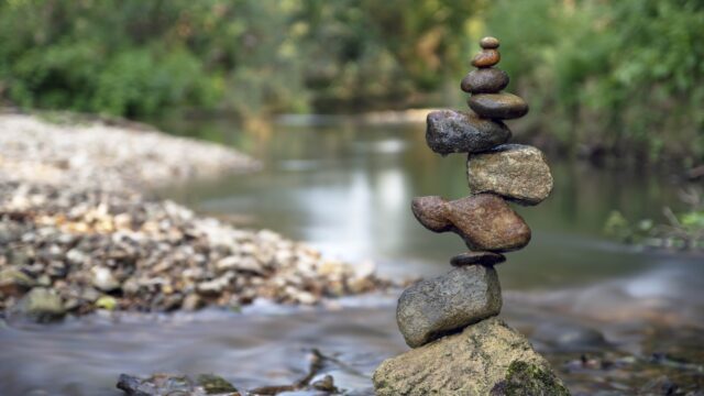 balancing rocks by river